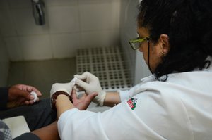 A patient makes rapid test for HIV, Hepatitis B, Hepatitis C and Syphilis in Alcohol Reference Center, Tobacco and Other Drugs (CRATOD)