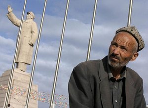 A Chinese Muslim man rests near a large statue of former Chinese leader Mao Zedong in Kashgar, Xinjiang, northwestern China, Sept. 17, 2003. China annouced Monday, Dec. 15 a list of name for 11 people and four groups that it accuses of Islamic separatist violence and appeals for foreign help to crush their movements.