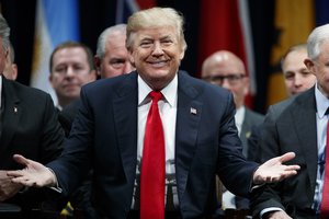 President Donald Trump gestures to the crowd at the FBI National Academy graduation ceremony, Friday, Dec. 15, 2017, in Quantico, Va.