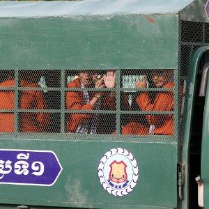 Members of the dissolved opposition Cambodia National Rescue Party inside a police vehicle in Phnom Penh.