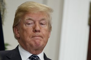 President Donald Trump listens as Secretary of Housing and Urban Development Ben Carson speaks during an event to honor Dr. Martin Luther King Jr., in the Roosevelt Room of the White House, Friday, Jan. 12, 2018, in Washington.