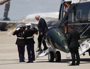 President Donald Trump, center, and first lady Melania Trump, right, arrive on Marine One helicopter at Andrews Air Force Base, Md., Wednesday, July 18, 2018. The president traveled to Andrews Air Force Base to pay their respects to the family of fallen U.S. Secret Service Officer special agent Nole E. Remagen,