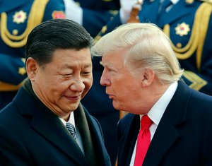 In this Nov. 9, 2017, file photo, U.S. President Donald Trump, right, chats with Chinese President Xi Jinping during a welcome ceremony at the Great Hall of the People in Beijing. Critics fear foreign government favors to Trump businesses have become business as usual. Recently there was the case of a Chinese-government company helping to build an Indonesian project that will include Donald Trump-branded properties. Just days later, the president tweeted his administration would ease sanctions against a Chinese phone maker accused of espionage. Ethics watchdogs say such apparent quid-pro-quo deals are not being stopped by a Republican-led Congress or the courts.