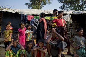 Rohingya Muslims, who crossed over from Myanmar into Bangladesh, wait to collect aid at Kutupalong refugee camp in Ukhiya, Bangladesh, Thursday, Dec. 21, 2017.