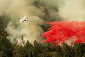 An air tanker drops retardant while fighting to stop the Ferguson fire from reaching homes in the Darrah community of unincorporated Mariposa Count, Calif., on Wednesday, July 25, 2018.