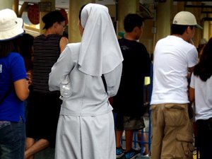 File - A Catholic nun, Sisters of Christian Charity, in Manila, the Philippines.