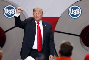 In this July 26, 2018, photo, President Donald Trump acknowledges the audience after speaking at the United States Steel Granite City Works plant in Granite City, Ill