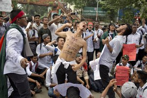 Bangladeshi students shout slogans and block a road during a protest in Dhaka, Bangladesh, Saturday, Aug. 4, 2018.