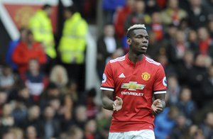 Manchester United's Paul Pogba celebrates after scoring his side's opening goal during the English Premier League soccer match between Manchester United and Arsenal at the Old Trafford stadium in Manchester, England, Sunday, April 29, 2018.