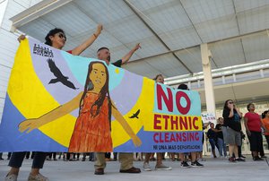 Protesters chant as they march during an immigration family separation protest in front of the Sandra Day O'Connor U.S. District Court building, Monday, June 18, 2018, in Phoenix. An unapologetic President Donald Trump defended his administration's border-protection policies Monday in the face of rising national outrage over the forced separation of migrant children from their parents.