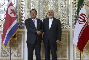 Iranian Foreign Minister Mohammad Javad Zarif, right, and his North Korean counterpart Ri Yong Ho shake hands for media at the start of their meeting in Tehran, Iran, Tuesday, Aug. 7, 2018.