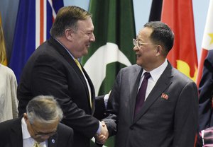 U.S. State Secretary Mike Pompeo, left, greets North Korea’s Foreign Minister Ri Yong-ho as they prepare to pose for a group photograph at the 25th ASEAN Regional Forum Retreat  in Singapore, Saturday, Aug. 4, 2018. (AP Photo/Joseph Nair)