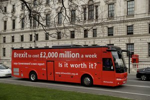 bus bearing the words "Brexit to cost £2,000 million a week" drives around Parliament Square, at the start a national campaign tour in central London, Wednesday, Feb. 21, 2018.