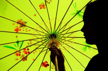 My daughter posing with her new souvenir parasol in Hoi An, Vietnam.