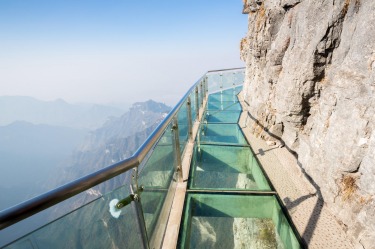 The Coiling Dragon Cliff Skywalk, China: One step up from a box on the side of a mountain is a glass-bottomed walkway ...