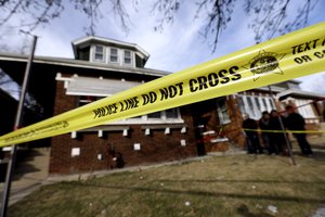 Crime scene tape surrounds a home on Sunday, Feb. 7, 2016, in Chicago.