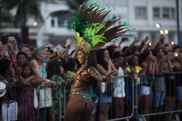 A member of a samba school parades along Copacabana Beach in Rio de Janeiro, Brazil. Musicians and members from Rio de ...