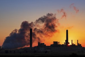 In this July 27, 2018, photo the Dave Johnson coal-fired power plant is silhouetted against the morning sun in Glenrock, Wyoming.