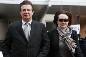 Paul Manafort, left, President Donald Trump's former campaign chairman, walks with this wife Kathleen Manafort, as they arrive at the Alexandria Federal Courthouse for an arraignment hearing on his Eastern District of Virginia charges, in Alexandria, Va., Thursday, March 8, 2018.