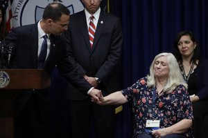 Pennsylvania Attorney General Josh Shapiro holds hands with Judy Deaven, who says her son was a victim of sexual abuse by a priest as a boy, during a news conference at the Pennsylvania Capitol in Harrisburg, Pa., Tuesday, Aug. 14, 2018