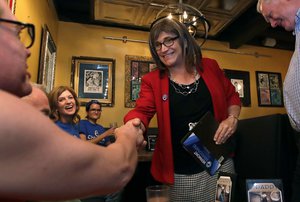 Vermont Democratic gubernatorial candidate Christine Hallquist, right, a transgender woman and former electric company executive, shakes hands with her supporters during her election night party in Burlington, Vt., Tuesday, Aug. 14, 2018.