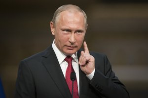 In this photo taken on Monday, May 29, 2017, Russian President Vladimir Putin gestures as he speaks during a shared news conference with French President Emmanuel Macron at the Palace of Versailles, near Paris, France.