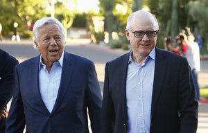 New England Patriots owner Robert Kraft, left, and New York Jets owner Woody Johnson, right, who is also U.S. ambassador to Britain, arrive for the opening of the NFL football annual meetings, Sunday, March 26, 2017, in Phoenix.