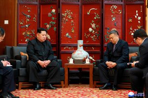 In this Monday, April 23, 2018, photo provided Tuesday, April 24, 2018, by the North Korean government, North Korean leader Kim Jong Un, left, meets China's ambassador to North Korea Li Jinjun, second from right, at the the Chinese Embassy following Sunday's traffic accident, in Pyongyang.