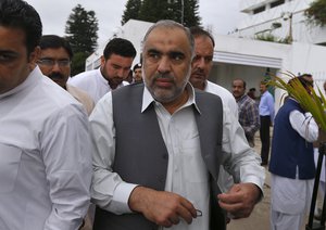 Newly elected lawmaker and candidate for speaker of the national assembly, Asad Qaiser, center, arrives to attend the first session of the lower house of parliament, in Islamabad, Pakistan, Monday, Aug. 13, 2018