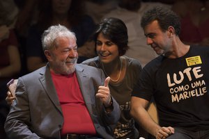 Brazil's former President Luiz Inacio Lula da Silva, left, talks to Manuela D'Avila of Brazil's Communist Party and Rio state Congressman Marcelo Freixo during his presidential campaign rally with members of his Workers Party and leaders of other left-wing parties in Rio de Janeiro, Brazil, Monday, April 2, 2018.