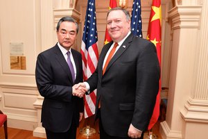 U.S. Secretary of State Mike Pompeo,on the right, shakes hands with Chinese State Councilor and Foreign Minister Wang Yi before their bilateral meeting at the U.S. Department of State in Washington D.C. on May 23, 2018