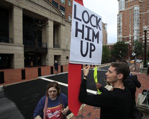 Protesters Gayelynn Taxey, left, and Danny Hastings, stand in front of the Alexandria Federal Court in Alexandria, Va., Tuesday, July 31, 2018, on day one of Paul Manafort's trial.