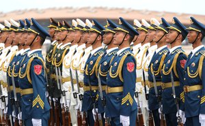 Chinese military guards giving honors (welcoming ceremony) during a state visit of Russian President Vladimir Putin outside the Great Hall of the People in Beijing, China