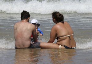 People enjoy the sea at Biarritz beach, southwestern France, Wednesday, July 25, 2018 as the hot weather continues across the country.