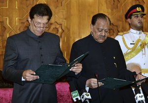 In this photo released by Press Information Department, Pakistani President Mamnoon Hussain, center, administers oath to newly-elected Prime Minister Imran Khan, left, at Presidential Palace in Islamabad, Pakistan, Saturday, Aug. 18, 2018.