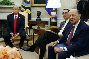 President Donald Trump sits with Secretary of Commerce Wilbur Ross, right, and Treasury Secretary Steve Mnuchin, center, during a meeting with European Commission president Jean-Claude Juncker in the Oval Office of the White House, Wednesday, July 25, 2018, in Washington.