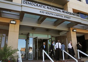 In this June 14, 2016 file photo, people stand outside the Democratic National Committee (DNC) headquarters in Washington.