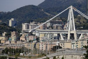 A view of the collapsed Morandi highway bridge in Genoa, Italy, Friday, Aug. 17, 2018. Excavators have begun clearing large sections of the collapsed highway bridge in the Italian city of Genoa in the search for people still missing three days after the deadly accident. (AP Photo/Gregorio Borgia)