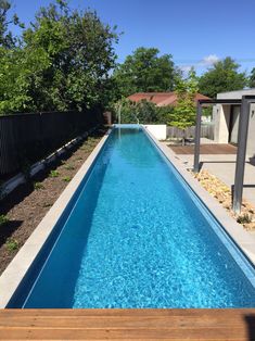 Above Ground Lap Pool With Remco Remote Controlled Pool Cover Stored Under Wooden Deck