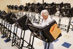 Voters cast their ballots among an array of electronic voting machines in a polling station at the Noor Islamic Cultural Center, Tuesday, Aug. 7, 2018, in Dublin, Ohio.