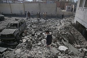 People inspect the rubble of a Houthi-held detention center destroyed by Saudi-led airstrikes in Sanaa, Yemen, Wednesday, Dec. 13, 2017.