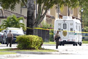 Miami-Dade police officers patrol after a standoff with a local judge on Friday, Aug. 24, 2018, near Princeton, Fla. (AP Photo/Brynn Anderson)