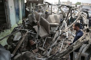 A man inspects the wreckage of a bus at the site of a deadly Saudi-led coalition airstrike on Thursday, in Saada, Yemen, Sunday, Aug. 12, 2018