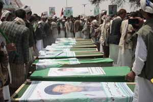 Yemeni people attend the funeral of victims of a Saudi-led airstrike, in Saada, Yemen, Monday, Aug. 13, 2018. Yemen's shiite rebels are backing a United Nations' call for an investigation into the airstrike in the country's north that killed dozens of people including many children. (AP Photo/Hani Mohammed)