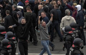 Men shout during a far-right protest in Chemnitz, Germany, Monday, Aug. 27, 2018 after a man has died and two others were injured in an altercation between several people of "various nationalities" in the eastern German city of Chemnitz on Sunday.