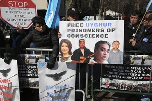 Uighurs and their supporters rally across the street from United Nations headquarters in New York, Thursday, March 15, 2018.