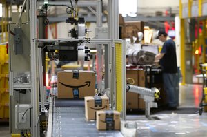 In this Aug. 3, 2017, file photo, packages pass through a scanner at an Amazon fulfillment center in Baltimore.