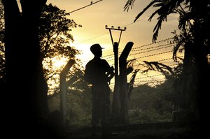 File - A Border Guard Police officer stands at a police post that was previously attacked by a Muslim terrorist group in Kyee Kan Pyin Buthidaung in which Myanmar government and military claim the existence of Muslim terrorists, in Rakhine state Myanmar, on Friday, July 14, 2017. Myanmar's military, accused of committing genocide during an aggressive counterinsurgency campaign in the heartland of the country's oppressed Muslim ethnic Rohingya minority, allowed journalists to previously off-limits areas on a guided press tour. (AP Photo/ A Border Guard Police officer stands at a police post that was previously attacked by a Muslim terrorist group in Kyee Kan Pyin Buthidaung in which Myanmar government and military claim the existence of Muslim terrorists, in Rakhine state Myanmar, on Friday, July 14, 2017. Myanmar's military, accused of committing genocide during an aggressive counterinsurgency campaign in the heartland of the country's oppressed Muslim ethnic Rohingya minority