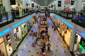 Interior of the Toronto Eaton Centre in Toronto, Ontario, Canada. A shopping mall, shopping centre, shopping arcade, shopping precinct or simply mall is one or more buildings forming a complex of shops representing merchandisers,