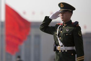 A Chinese paramilitary policeman salutes near the Great Hall of the People where the opening session of the Chinese People's Political Consultative Conference (CPPCC) was held in Beijing, China, Friday, March 3, 2017.